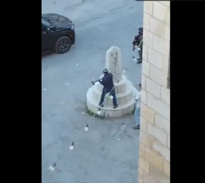 In front of the cameras… a Knesset member demolishes a memorial in the West Bank (video)